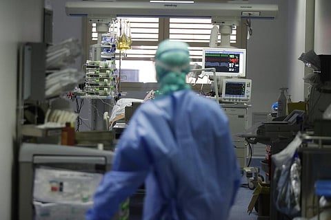 In this Monday, March 16, 2020 file photo, a doctor watches a coronavirus patient under treatment in the intensive care unit of the Brescia hospital, Italy. (Photo | AP)
