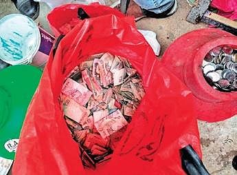 The currency notes and coins found at Prabhavathi’s home | Express