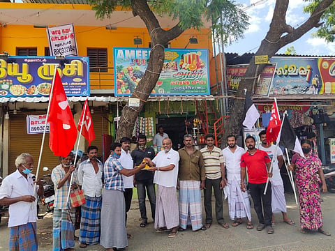 Communist party men distributing sweets to the public at Udangudi in Thoothukudi district.