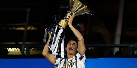 Cristiano Ronaldo with the Serie A trophy as Juventus players celebrate winning an unprecedented ninth consecutive title. (Photo | AP)