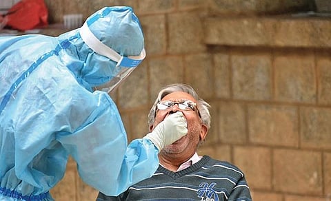 An elderly man gives his sample for COVID-19 testing at a clinic. (Photo | Meghana Sastry, EPS)