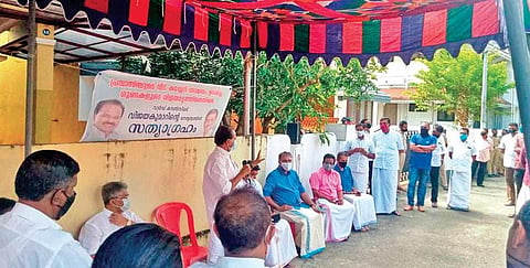 P T Thomas, MLA, addresses a dharna in front of the house