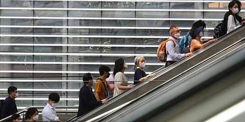 People wearing face masks to help protect against the spread of the coronavirus ride an escalator at the Seoul Railway Station, South Korea. (Photo | AP)