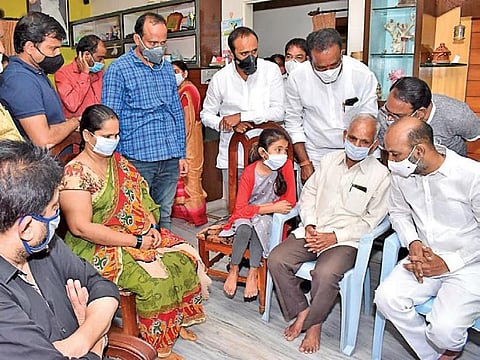 BJP Telangana president Bandi Sanjay consoles the family members of Divisional Engineer Srinivas Goud, who died in the Srisailam mishap, on Tuesday.