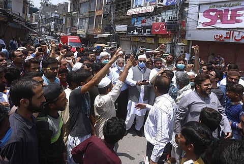 Shopkeepers stage a protest at a market demanding the government allow them to reopen their businesses and condemn a new lockdown imposed by the provincial government in Punjab (Photo | AP)