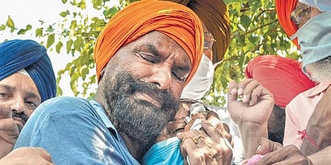 Relatives of a hooch tragedy victim get emotional in Tarn Taran on Sunday. (Photo | PTI)