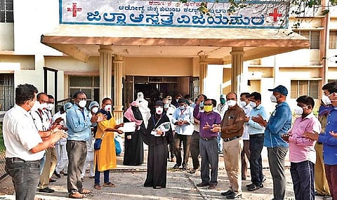Hospital workers cheer as patients leave the hospital after successfully recovering from Covid-19, in Vijayapura | Express