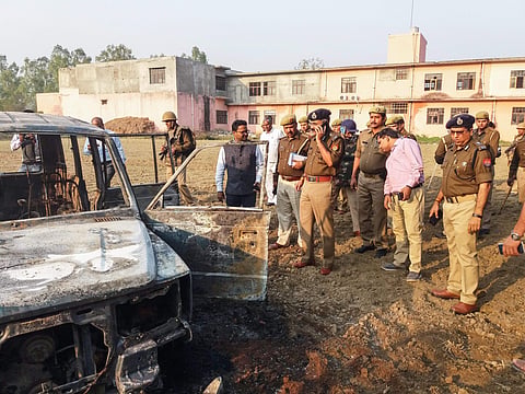 Cops inspect after several vehicles were set on fire by a mob during a protest over the alleged illegal slaughter of cattle in Bulandshahr Monday. (File photo | PTI)