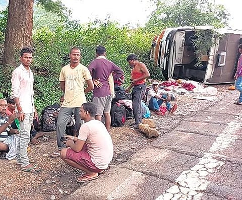 Injured migrant workers take rest near the ill-fated bus on Thursday | Express