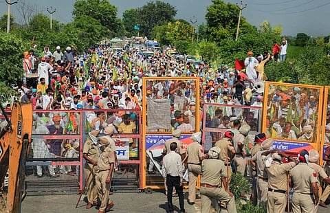Sri Muktsar Sahib Police stand guard near barricades as Bhartiya Kisan Union activists protest against three ordinances passed by the Centre. (Photo | PTI)