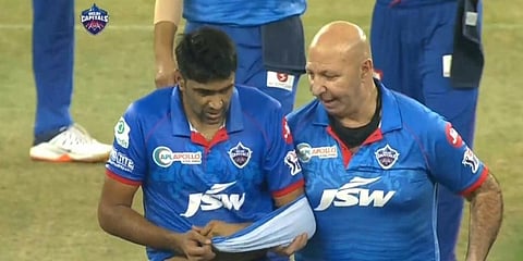 R Ashwin's jersey became a temporary sling as he left the field along with Capitals' physio Patrick Farhard. (Twitter Photo)