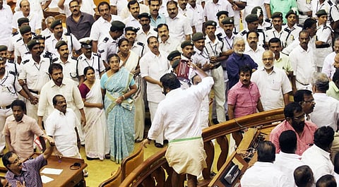 Shining? Not quite! MLA V Sivankutty seen raising an emergency lamp from the Speaker's dais in this 2015 budget session file photo. (EPS)