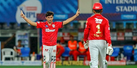 Kings XI Punjab's Ravi Bishnoi celebrates with his teammates after dismissing RCB's Umesh Yadav. (Photo | PTI)