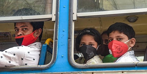 Commuters travel in a bus wearing masks. (Photo | PTI)