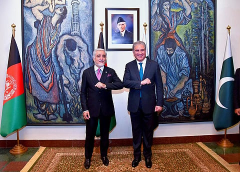 Abdullah Abdullah, left, chairman of Afghanistan's High Council for National Reconciliation, bumps elbows with Pakistani Foreign Minister Shah Mahmood Qureshi. in Islamabad. (Photo | AP)