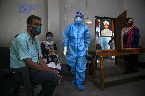 An Indian health worker prepares to take nasal swab samples of teachers to test for COVID-19 at a school before classes open in Gauhati, India, Wednesday, Sept. 2, 2020. (Photo | AP)