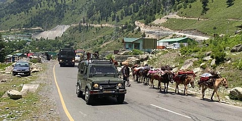 An Indian army convoy moves on the Srinagar-Ladakh highway at Gagangeer, north-east of Srinagar. (Photo | AP)