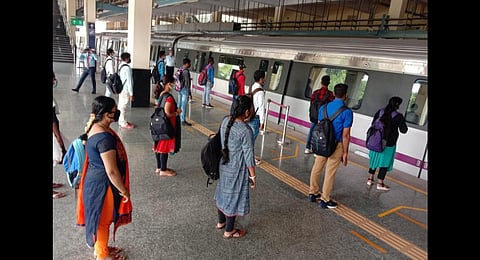 A demonstration by Metro staffers on how passengers should maintain social distancing while boarding. (Photo | Express)