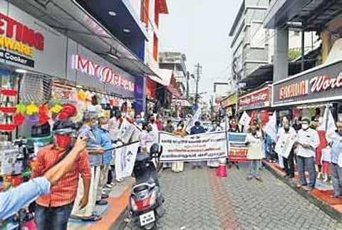 General merchants of Broadway protesting in front of the barricades seeking their removal on Monday | Arun Angela