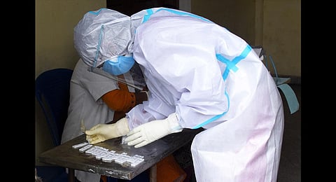 A health worker sorts out swab samples while conducting Covid tests. (Photo | Udayshankar S, EPS)