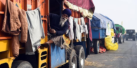A farmer sitting inside a parked truck at Ghaziabad border on a chilling afternoon. (Photo| Parveen Negi, EPS)