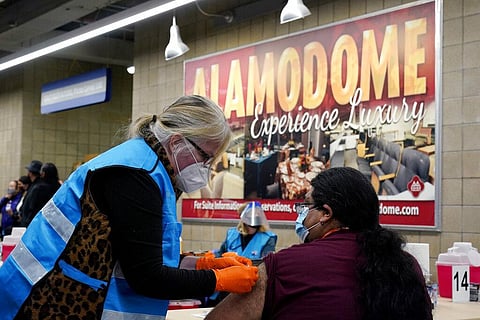 A health care worker administers a COVID-19 vaccination at the new Alamodome COVID-19 vaccine site, Monday, Jan. 11, 2021. (Photo | AP)