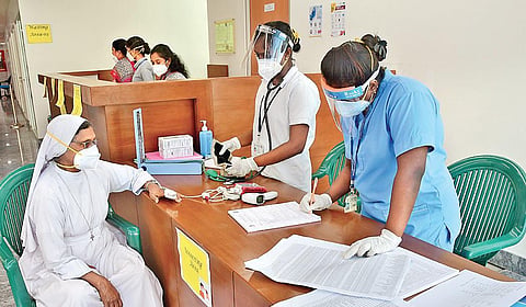 Health workers conduct pre-vaccination checkup on a nun before she gets the first shot of Covishield vaccine at St Philomena’s Hospital in Bengaluru on Sunday | Ashishkrishna HP