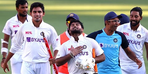 Rishabh Pant (C) gestures as team celebrate victory in the fourth cricket Test match against Australia at The Gabba in Brisbane. (Photo | AFP)