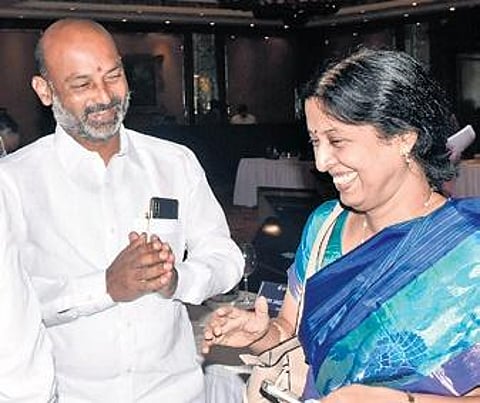Bandi Sanjay shares a lighter moment with bureaucrat Y Srilakshmi at the Parliamentary Standing Committee Meeting in Hyderabad. (Photo | Express)