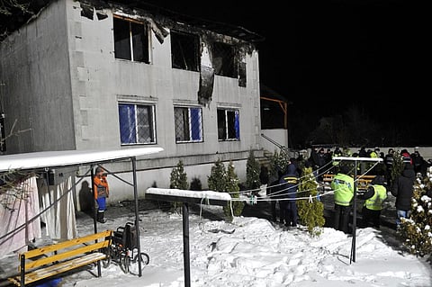 Police experts and members of the State Emergency Service of Ukraine work on the the site of a fire that broke out. (Photo| AFP)