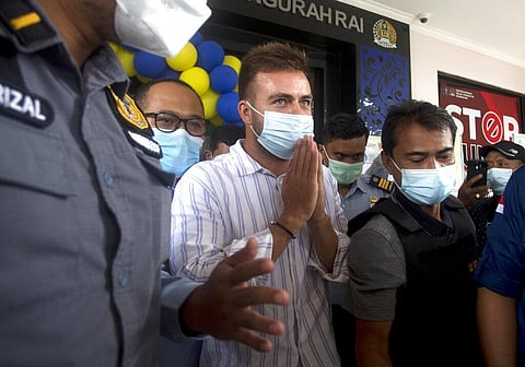 Russian citizen Sergei Kosenko, center, is escorted by Indonesian immigration officers at Immigration office in Nusa Dua, Bali, Indonesia on Sunday. (Photo | AP)