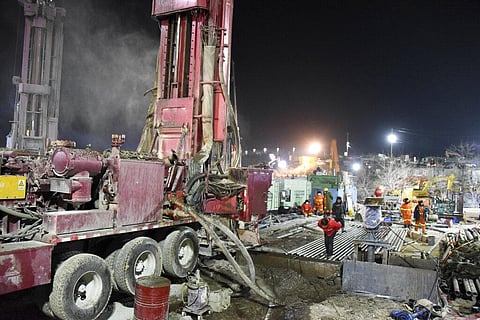 Rescuers drill a new channel at the explosion site of a gold mine in Qixia City. (File photo | AP)
