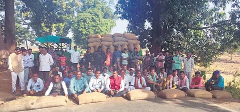 Farmers blocking the Pandigaon-Mukhiguda road with paddy bags on Monday.