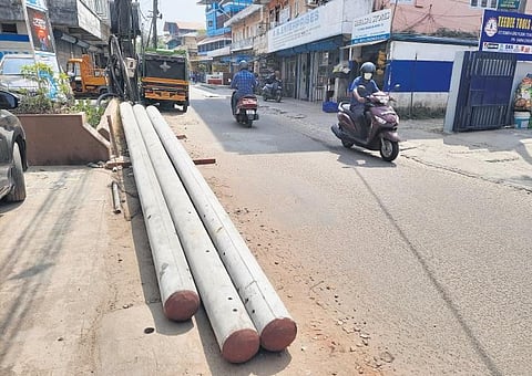 Uninstalled LED light poles kept on the left side of the already congested TD Road.