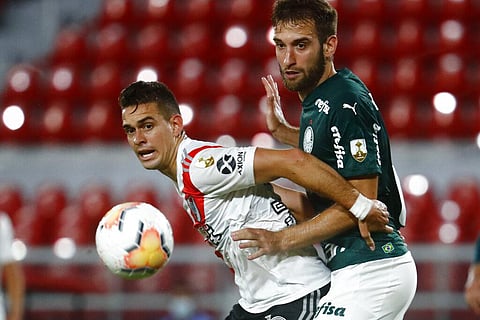 Matias Vina of Brazil's Palmeiras, right, and Rafael Santos Borre of Argentina's River Plate battle for the ball during a Copa Libertadores soccer semifinal match. (Photo | AP)