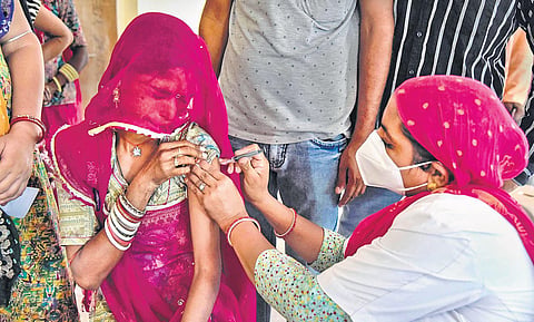 A health worker administers vaccine to a woman at a special camp in Bikaner | PTI