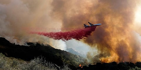 An air tanker drops retardant on a wildfire in Goleta, Calif. (Photo | AP)