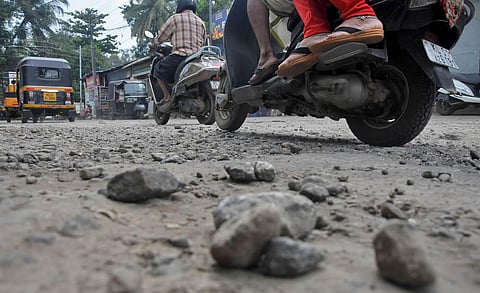 Motorists stuggle to navigate through potholes at Aryasala in Thiruvananthapuram. (Photo | B P Deepu, EPS)