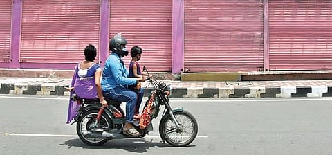 For children below four years, safety harness shall be used for attaching the child to the driver of the motorcycle. (Photo | P Ravindra Babu)