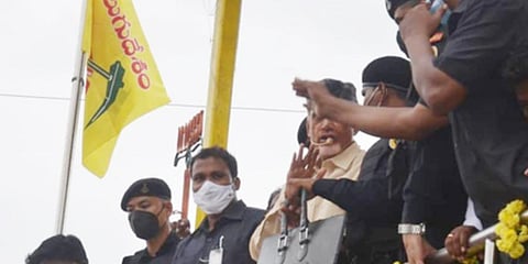 TDP chief N Chandrababu Naidu being guarded by security staff during his roadshow in Kuppam. (Photo | EPS)
