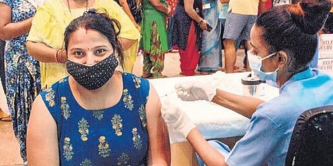 A health worker administers COVID vaccine at District hospital, Noida. (Photo | PTI)