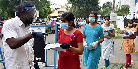 Security personnel checking the documents of a medical aspirant outside a NEET Examination centre in Coimbatore. (Photo| U Rakesh Kumar, EPS)