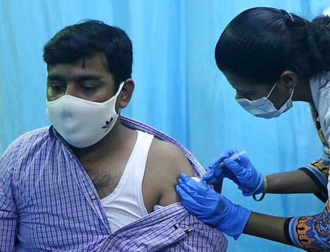 A health worker inoculates a school teacher Mohammed Haseeb Khan with the vaccine for COVID-19 during a special drive for teachers and students in Mumbai. (Photo | AP)
