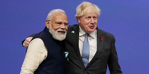 British PM Boris Johnson (R) greets PM Narendra Modi, at the COP26 U.N. Climate Summit in Glasgow, Scotland. (Photo | AP)