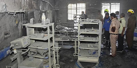 People inspect the civil hospital's COVID-19 ward that caught fire in Ahmednagar. (Photo | AP)