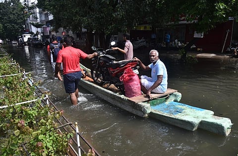 In Chennai, local residents still sailing on boats to cross the localities at Peravallur, Kolattur, following flooding caused by recent rains. (Express I P Jawahar)