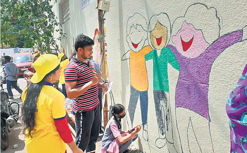 Students painting the walls of AJS Nidhi High School. (File photo)