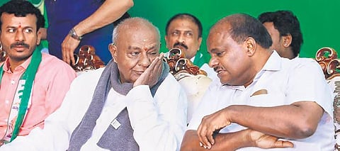 Former PM HD Deve Gowda has a word with his son HD Kumaraswamy at the JDS’ ‘Janata Sangama’ workshop in Bengaluru on Tuesday | EXPRESS