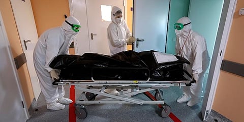 Medics wearing special suits to protect against coronavirus transport the body of a COVID-19 victim at an ICU of a hospital in Kalach-on-Don, 73 km south-east of Rostov-on-Don, Russia. (Photo | AP)