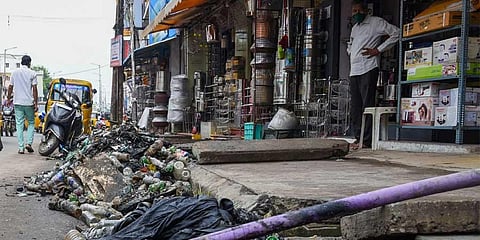 Bottles, waste removed from drainage on Palakarai main road. (MK Ashok Kumar | EPS)